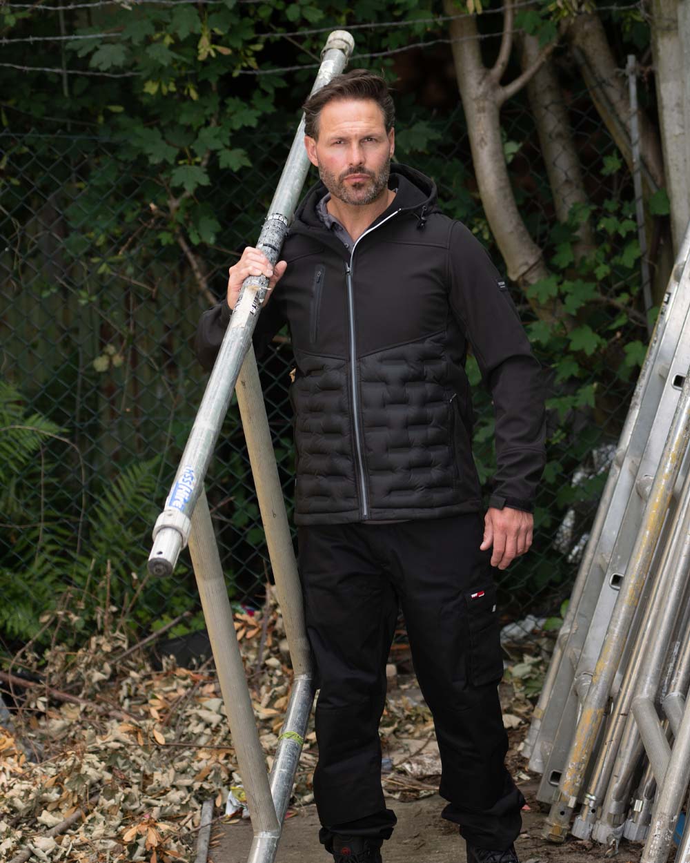 Black Coloured Tuffstuff Mens Stratford Softshell Jacket on garden background 