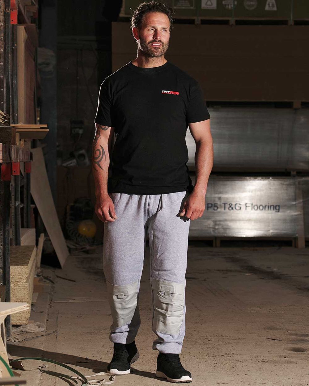 Grey Coloured TuffStuff Comfort Work Trouser On A Factory Background 