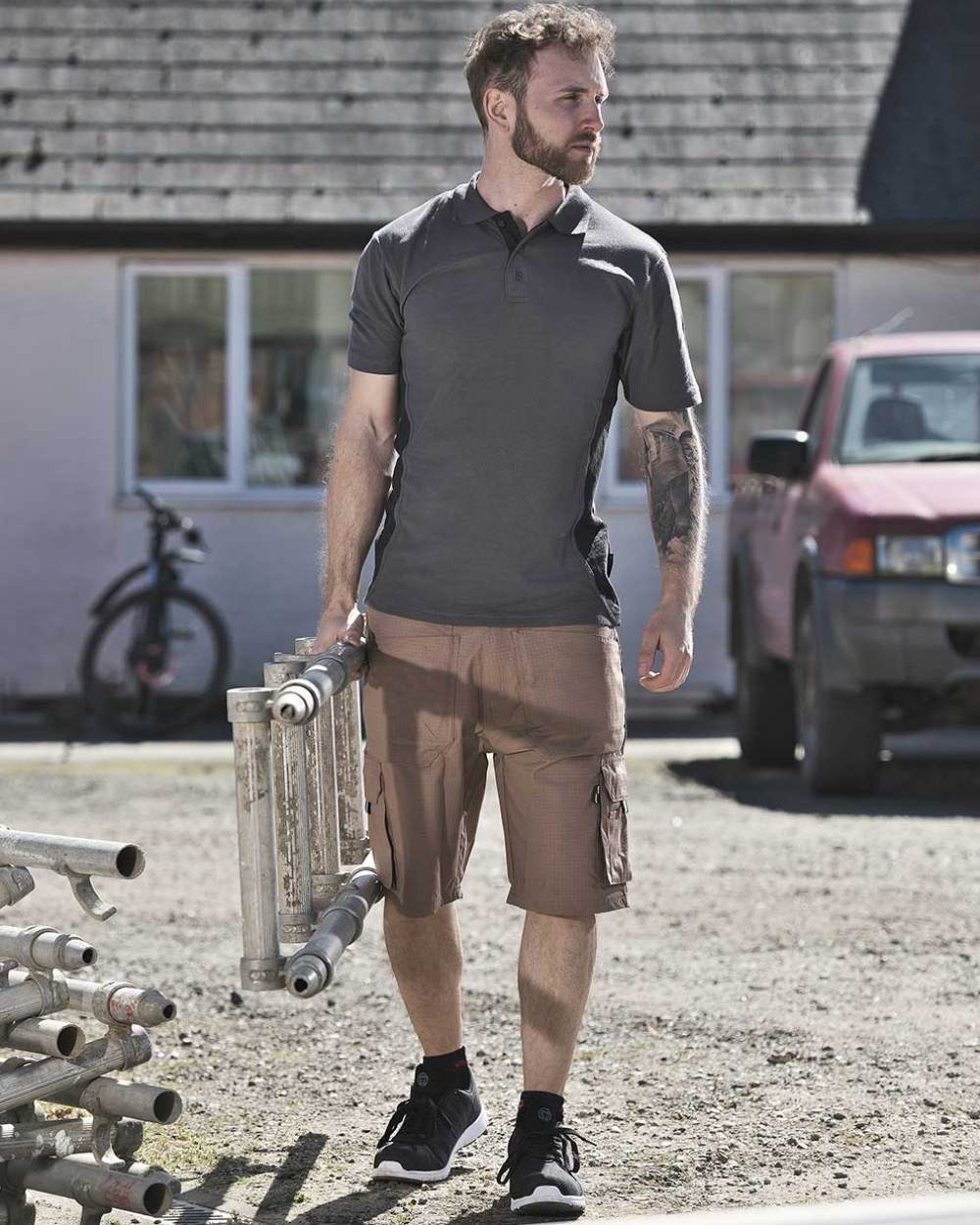 Sand Coloured TuffStuff Enduro Work Shorts On A Warehouse Background 