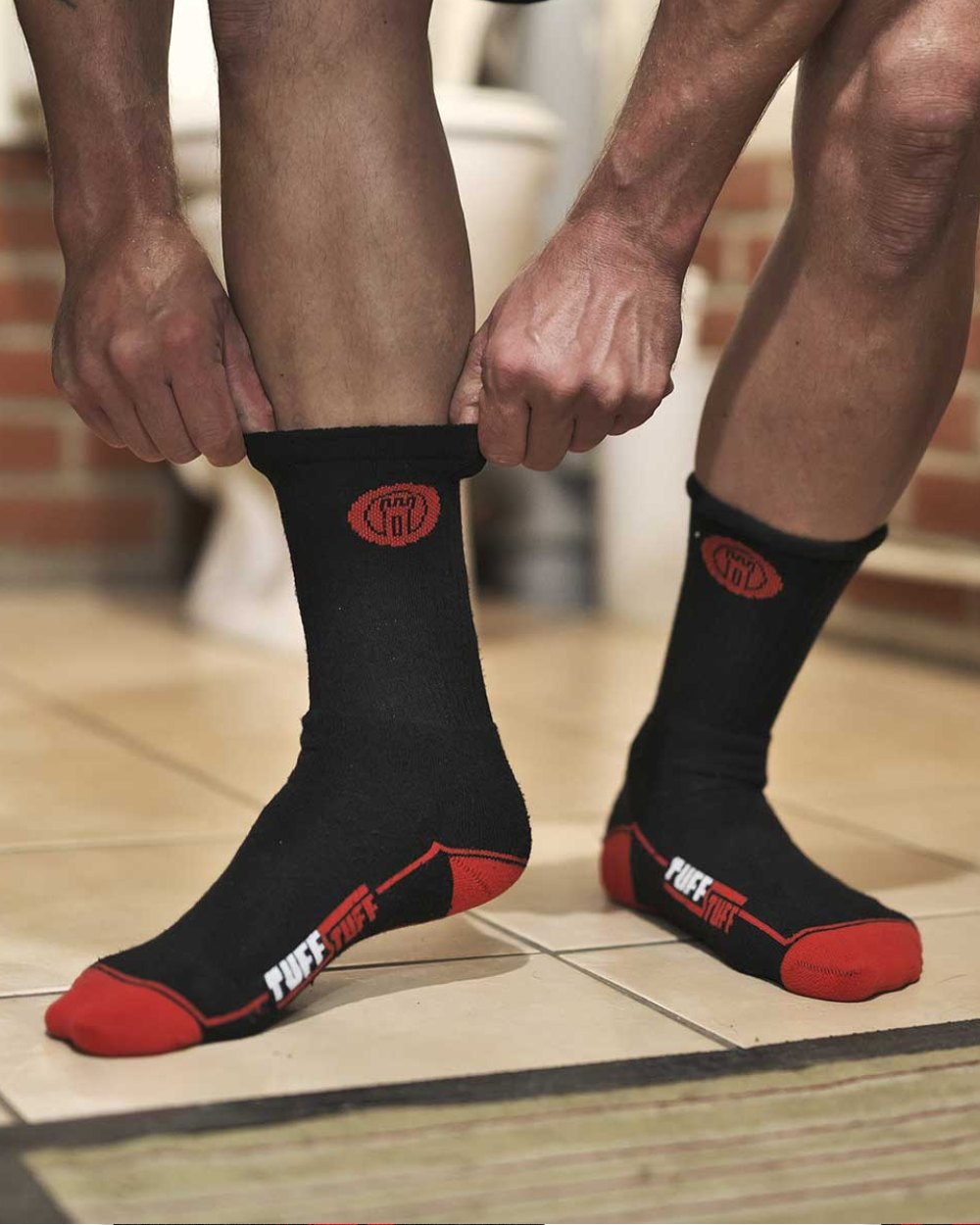 Black Red Coloured TuffStuff Extreme Socks On A Rest Room Background