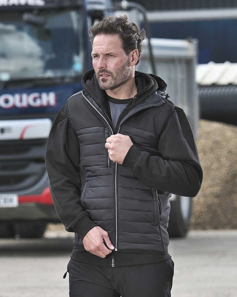 Black Coloured TuffStuff Howden Hooded Bodywarmer On A Street Background