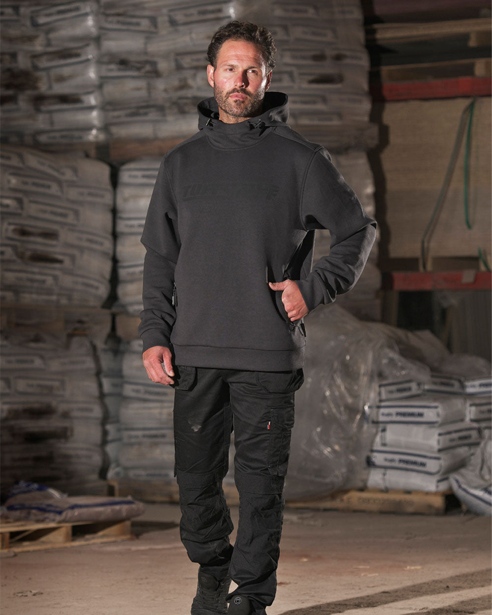 Grey coloured TuffStuff Hudson Hoodie on Warehouse Background