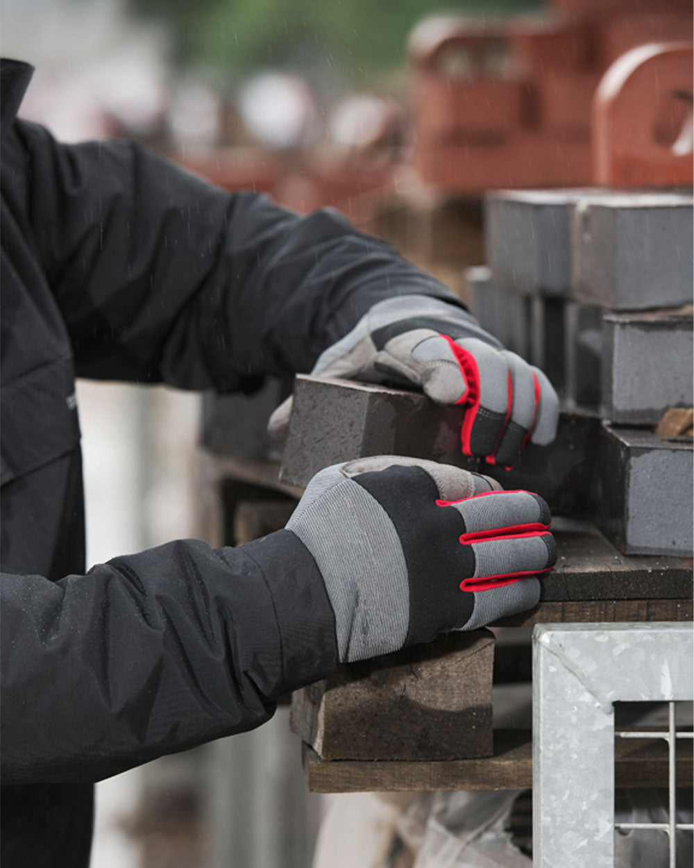 Black coloured TuffStuff Pro Work Gloves on Construction Background