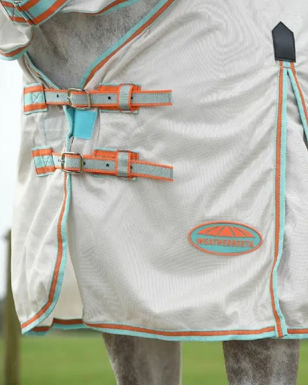 Beige Turquoise Orange coloured WeatherBeeta ComFiTec Essential Mesh II Combo Neck on blurry background 