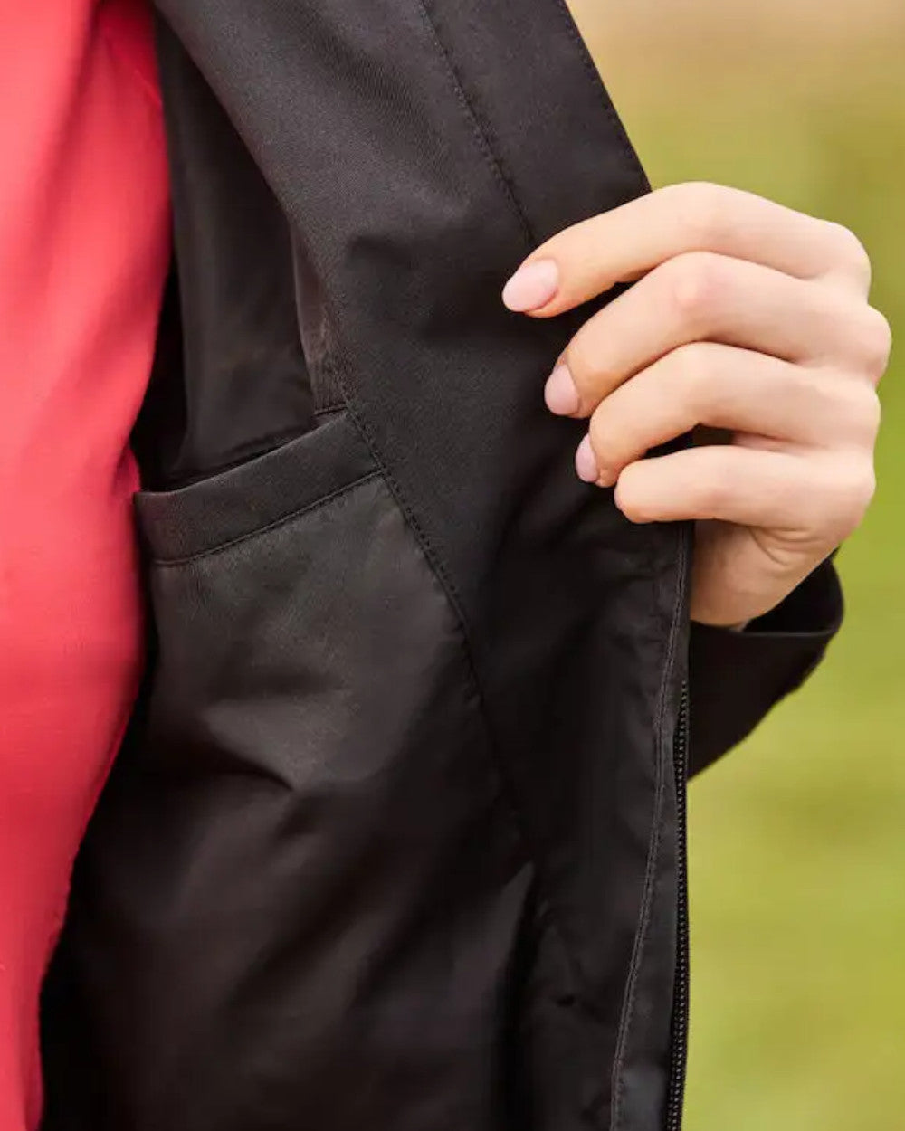 Black Coloured WeatherBeeta Jackson Waterproof Jacket On A Field  Background 