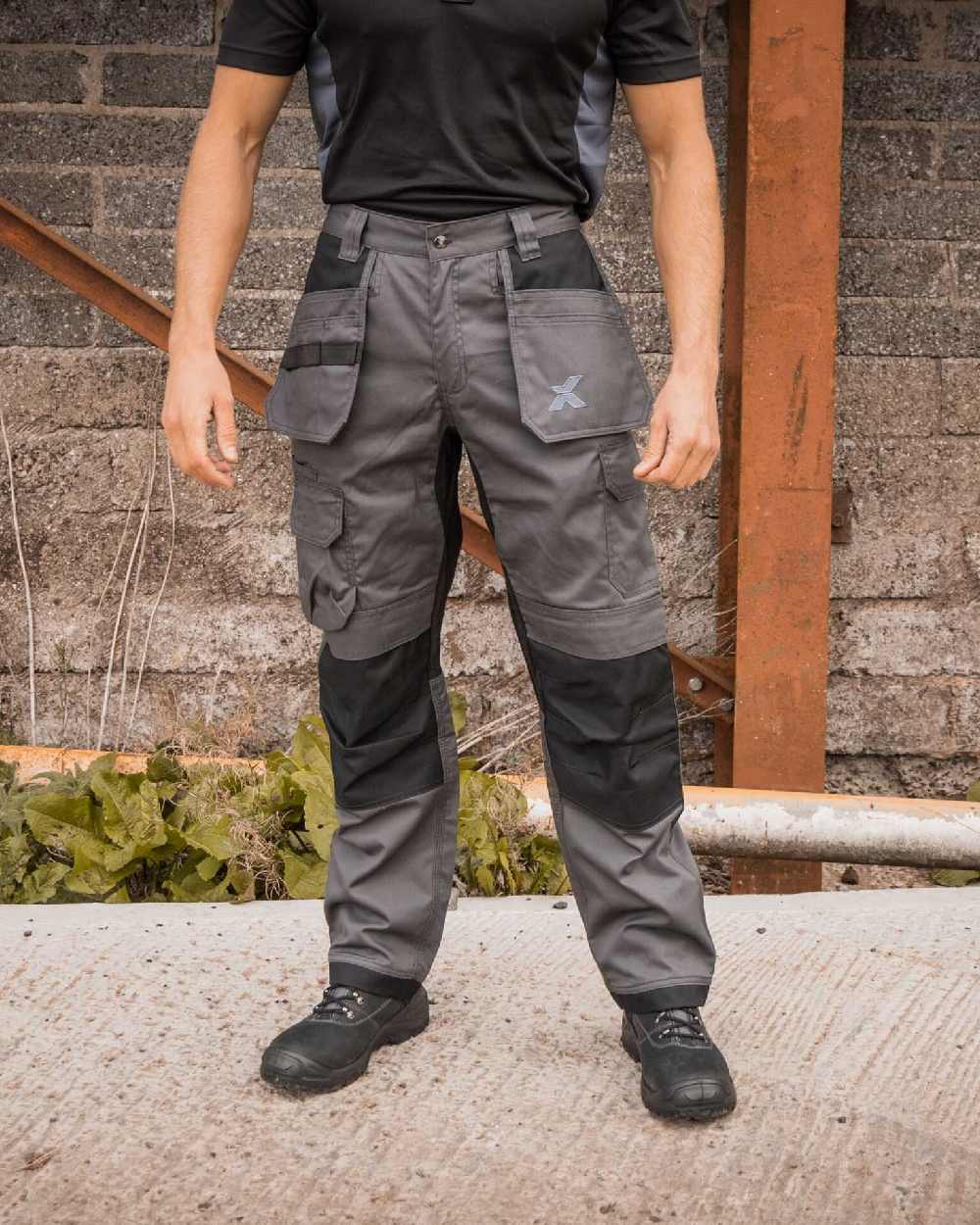 Grey Black Coloured Xpert Mens Core Stretch Work Trousers on Outdoor Background
