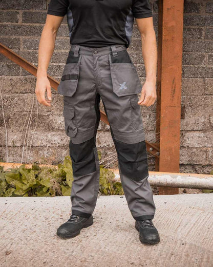 Grey Black Coloured Xpert Mens Core Stretch Work Trousers on Outdoor Background

