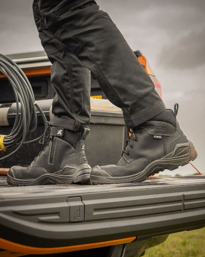 Black Coloured Xpert Mens Pro Zipster Safety Zip-Side Boots on Outdoor Background

