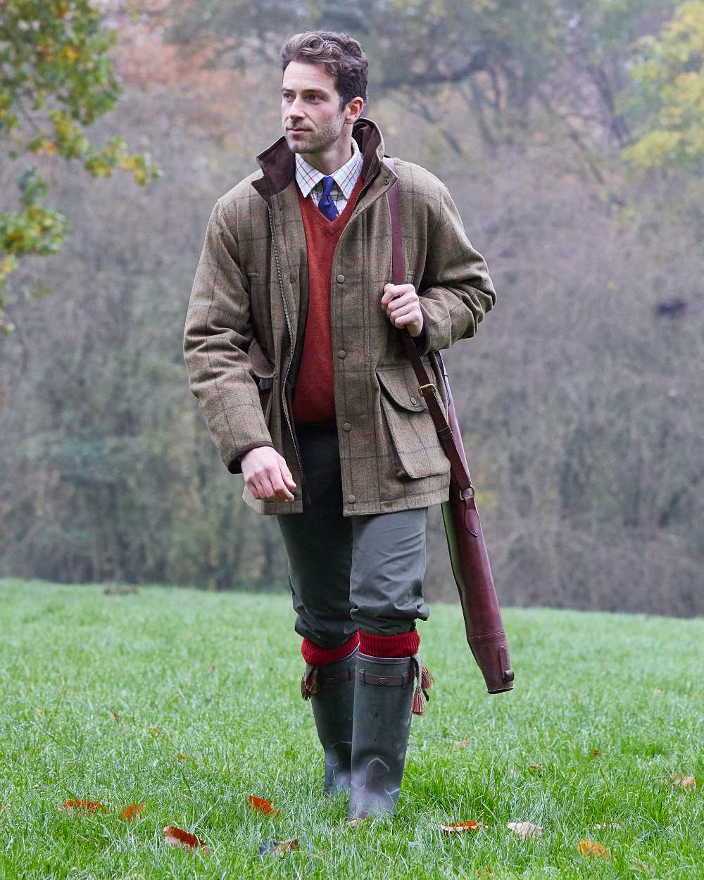 Thyme coloured Alan Paine Mens Combrook Field Coat on blurry forest background 