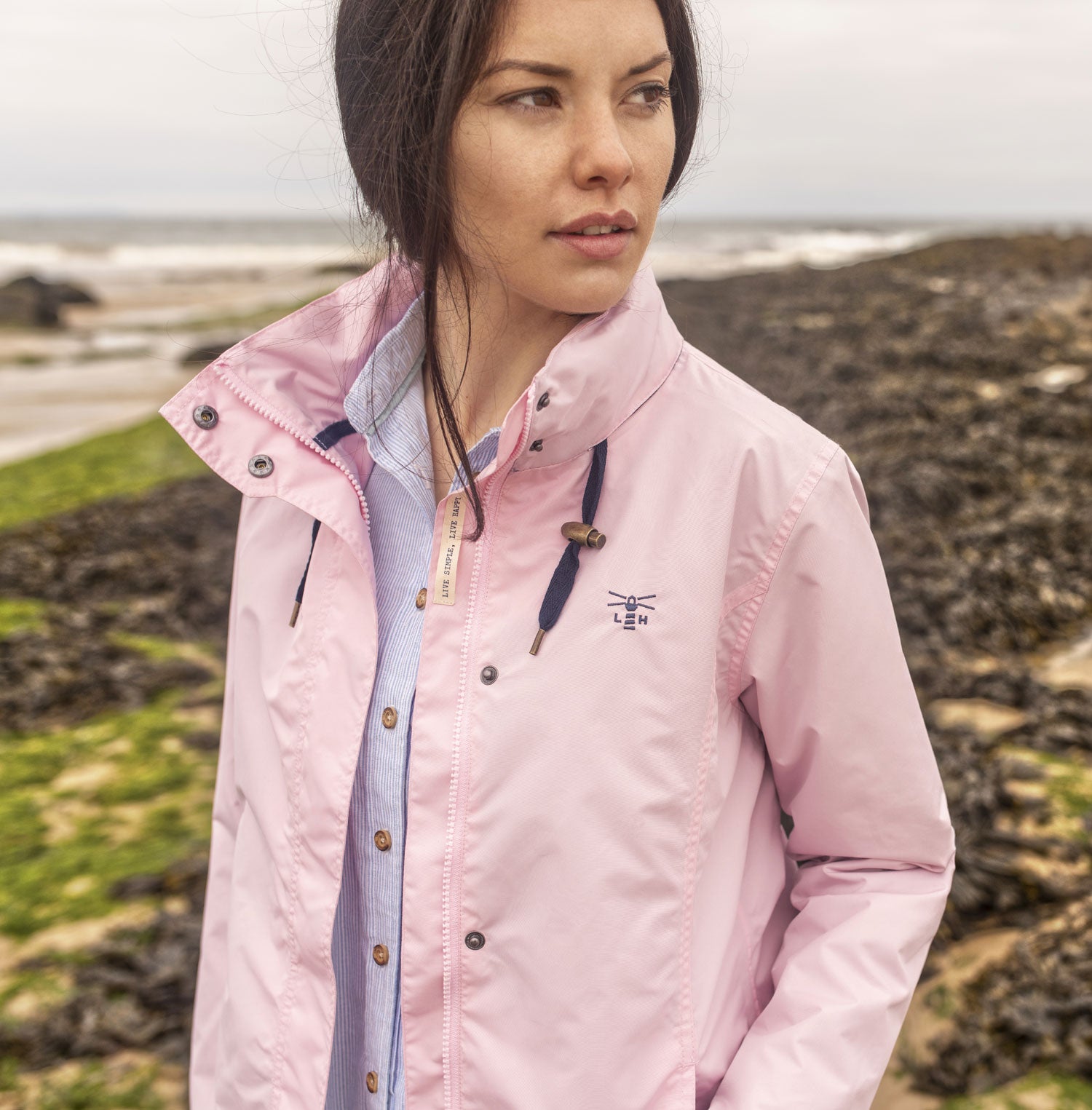 Lady on the beach wears Lighthouse Beachcomber Waterproof Jacket