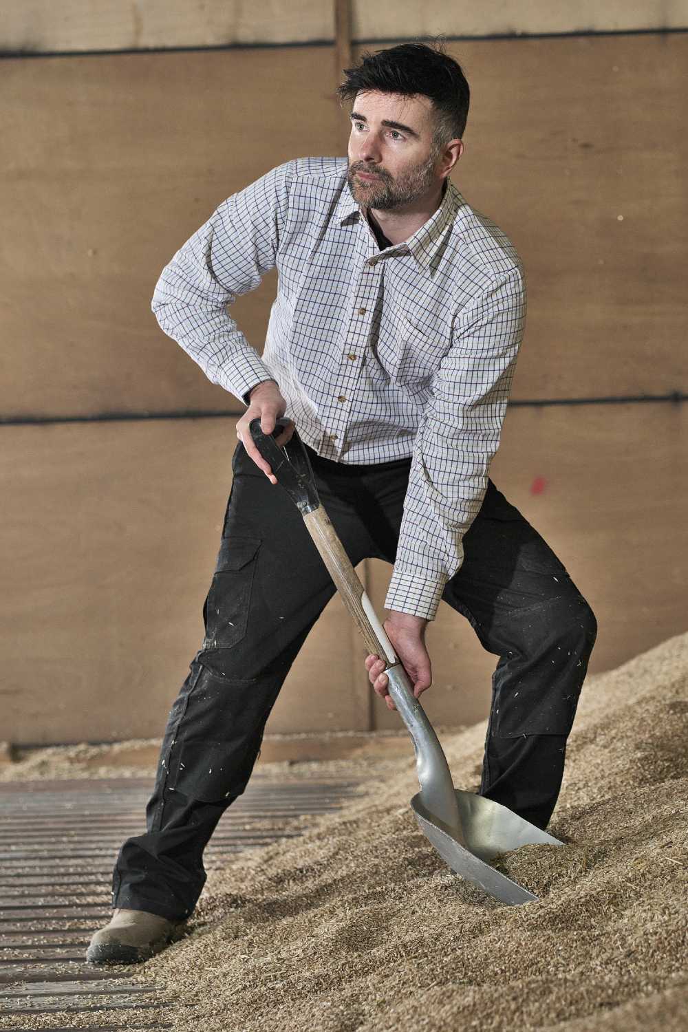 Shovelling grain wearing Fort Tattersall Work Shirt 