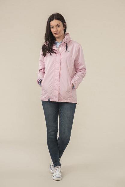 Lady wears Lighthouse Beachcomber Waterproof Jacket in Pink